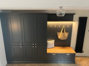 Beau Bijou design. Boot room featuring shaker timber carbon frontals, moulded plinth, solid timber seating and shelf, and coat hooks on a tongue and groove back panel